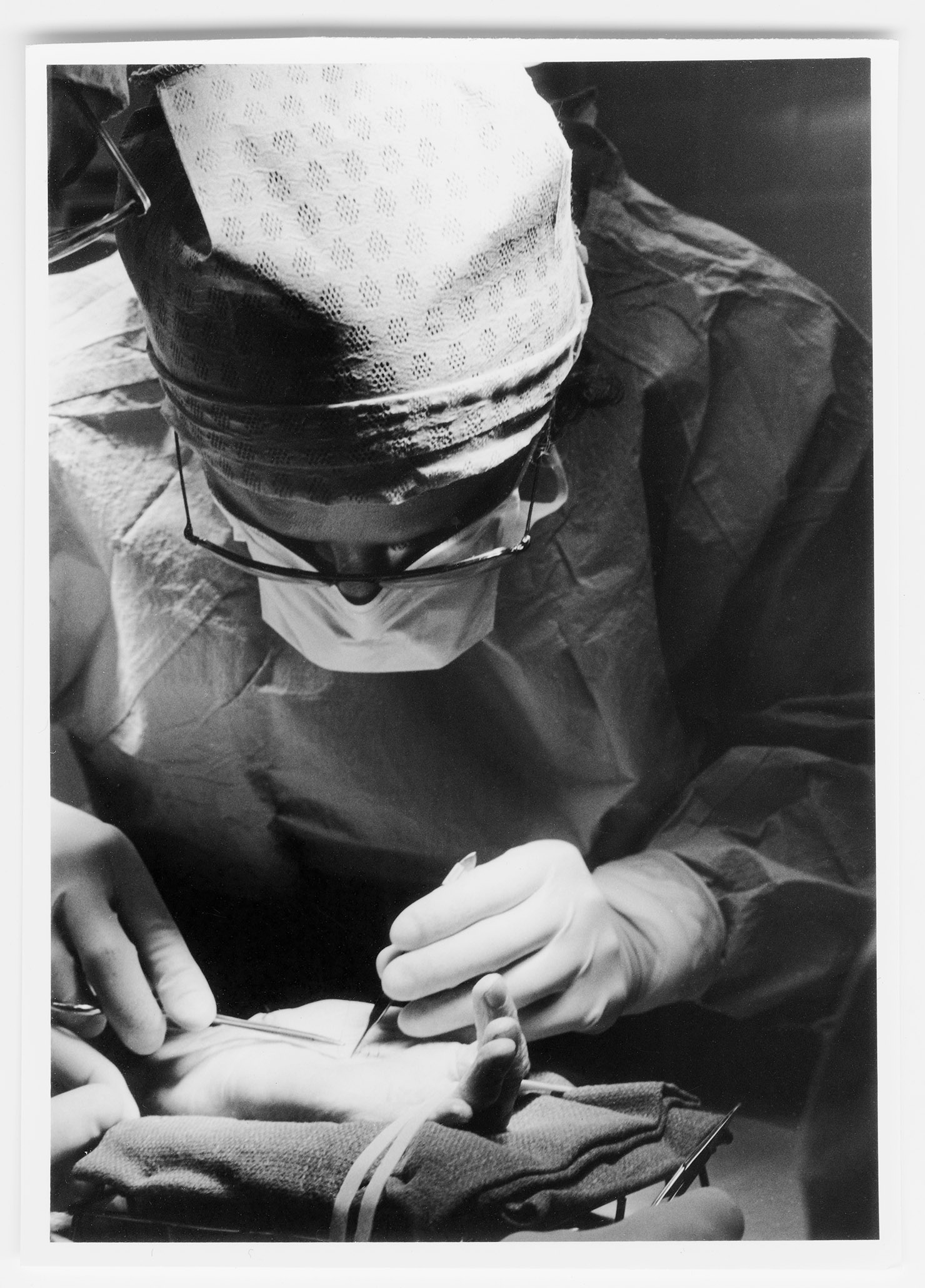 Williams performing surgery on a hand