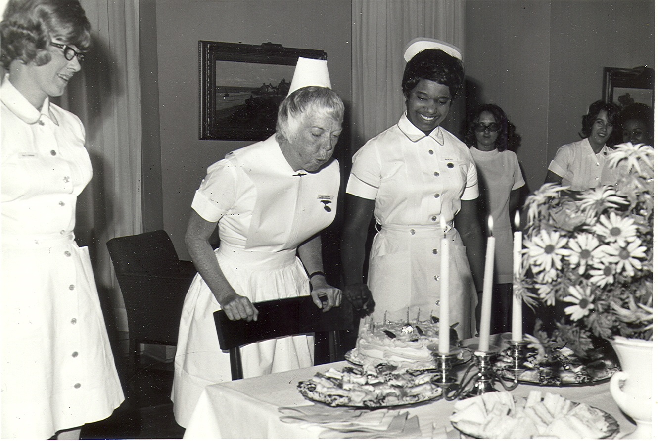 chalmers nurse blows out candles on a birthday cake