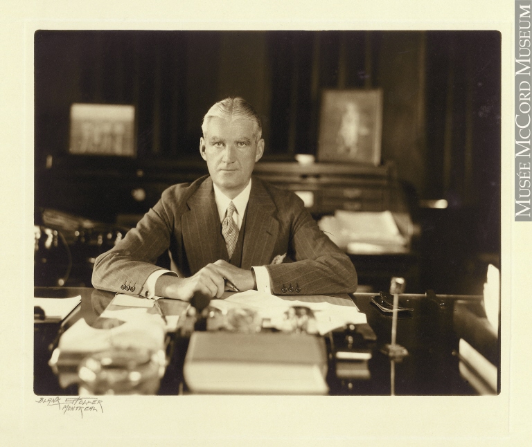 John W. McConnell at his desk